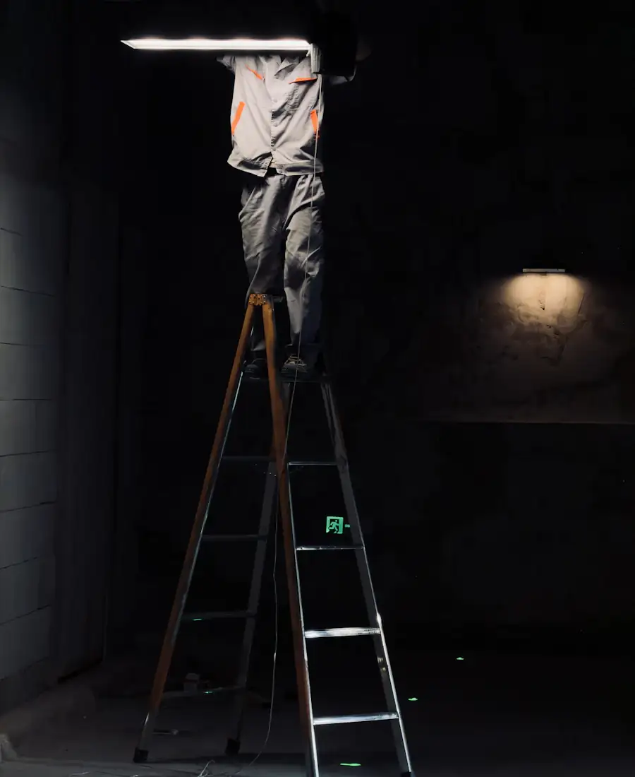 Electrician installing a light fixture