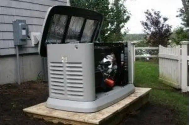 Standby generator installed beside a house